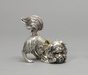 6916 A silver okimono (decorative object) of a Pekingese dog playing with
